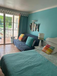 a living room with a bed and a couch at la Désirade in Sainte-Luce