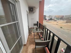 a balcony with a table and chairs and a view of a street at FRANMAY APARTMENTS - 7 modern apartments near the beach & city in Santa Maria