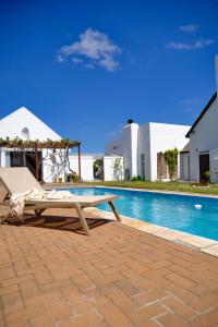 a pool with a table and a bench next to it at MM Good Times in Gansbaai