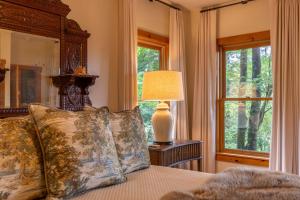a bedroom with a bed with a large window at Altitudes Attitude in Blowing Rock