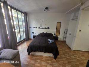 ein Schlafzimmer mit einem Bett in einem Zimmer mit Fenstern in der Unterkunft Aventura Playa y Sol Santa Pola in Santa Pola