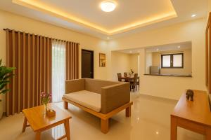 a living room with a couch and a table at Shitala Villa in Munduk