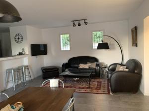 a living room with a couch and a table at Le mas saint augustin in La Crau