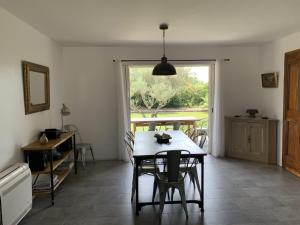 a dining room with a table and a window at Le mas saint augustin in La Crau