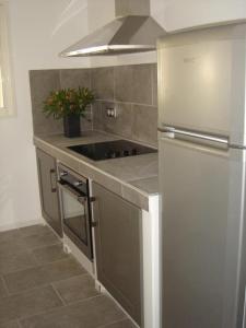 a kitchen with a refrigerator and a stove top oven at Le mas saint augustin in La Crau +12 photos