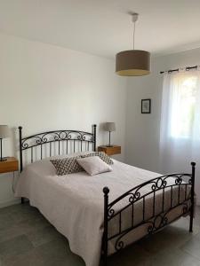 a bedroom with a large bed with a white bedspread at Le mas saint augustin in La Crau