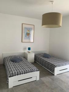 two beds sitting next to each other in a room at Le mas saint augustin in La Crau