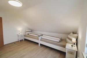 a room with a couch with two pillows on it at Küstenkind in Spieka-Neufeld