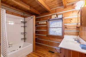 a bathroom with a tub and a sink and a shower at Daniel Boone Lodge in Boone +63 photos