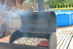 a grill with a bunch of food on it at Viesu namiņš Dālderi in Varakļāni