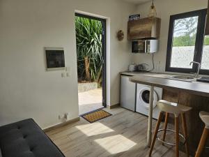 a kitchen with a table and a counter with a microwave at Studio Belle Place in Le Gosier