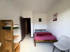 a bedroom with a bed and a ladder and a chair at Marie Begue Villa in Cilaos