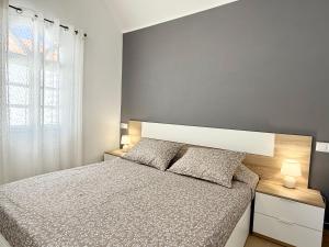 a bedroom with a bed and a large window at Oceanica home in Mogán +15 photos