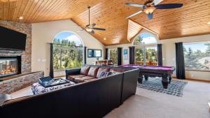 a living room with a couch and a pool table at Linaker Lodge by AvantStay Gorgeous Cabin in Big Bear w Views in Big Bear Lake