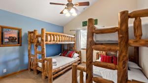 a bedroom with two bunk beds and a couch at Linaker Lodge by AvantStay Gorgeous Cabin in Big Bear w Views in Big Bear Lake