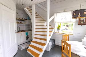 a staircase in a tiny kitchen with a table at Brinken 3 in Sörberge