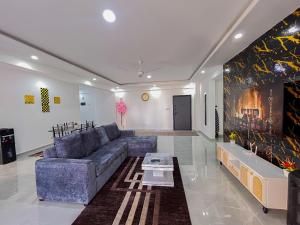 a living room with a couch and a table at Madzo Holiday homes in Mombasa