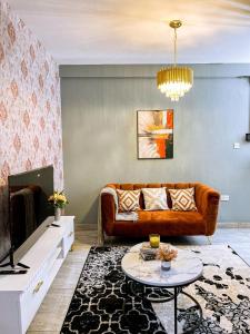 a living room with a couch and a table at Eliana Apartment in Kampala