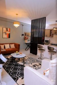 a living room with a couch and a table at Eliana Apartment in Kampala