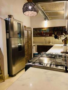 cocina con fogones y nevera de acero inoxidable en Rest Place In Trancoso, en Porto Seguro