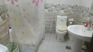 a bathroom with a toilet and a sink at سوما للشقق المفروشه Soma apt in Al Madinah