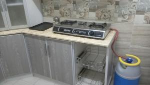 a stove sitting on a counter in a kitchen at سوما للشقق المفروشه Soma apt in Al Madinah +45 photos