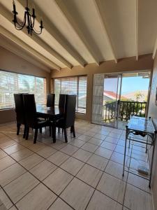 a dining room with a table and chairs and a balcony at 21A on Edgerton in Freeland Park