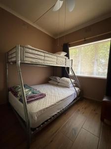 a bunk bed in a room with a window at 21A on Edgerton in Freeland Park +14 photos