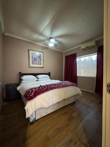 a bedroom with a bed and a window at 21A on Edgerton in Freeland Park