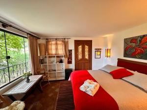 a bedroom with a large bed and a balcony at Chalés ANECUEM in Monte Verde +50 photos