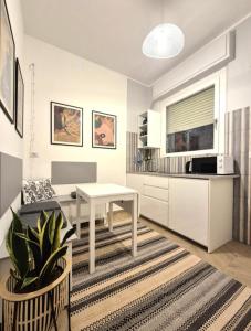 a living room with a table and a kitchen at Sole e Mare Apartment in Pescara