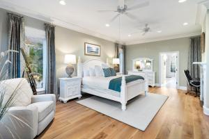 a bedroom with a white bed and a couch at OP58: 58 Ocean Point in Isle of Palms +47 photos