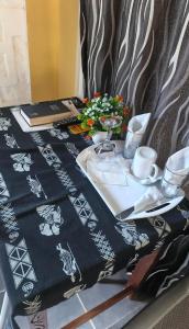 a table with a black and white table cloth on it at Sandfields Lodwar Resort and Spa in Lodwar