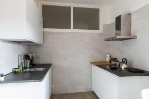 a kitchen with a sink and a counter top at Wellness Holiday Home - Self Check-in & Access in Brunate