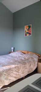 a bed in a bedroom with a painting on the wall at Studio for 2 people with pool in Saint-Avit-Sénieur