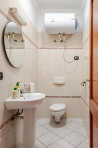 a bathroom with a toilet and a sink and a mirror at Modern Elegance & Moroccan Charm - Gueliz Center in Marrakech +17 photos