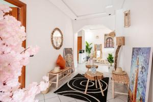 a living room with white walls and a black rug at Modern Elegance & Moroccan Charm - Gueliz Center in Marrakech