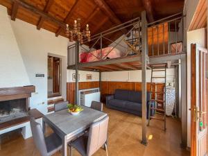 a living room with a loft bed and a dining room at Welcome traveller Benaco Chalet in Torri del Benaco