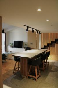 a kitchen with a large table and some chairs at Modern Duplex Loft in Skopje City Center with 3 Bedrooms in Skopje