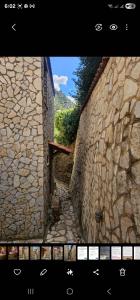 a screenshot of a video of a stone wall at Airb nb Zachlorou in Kalavrita