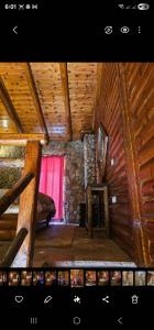 a room with a fireplace in a wooden cabin at Airb nb Zachlorou in Kalavrita
