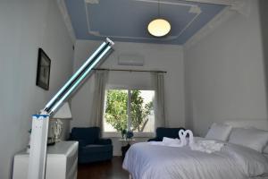 a bedroom with a white bed and a blue ceiling at Villa Lu Bartolo - Room Rose in Taʼ Lampuka