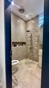 a bathroom with a shower and a toilet in it at Coming Soon Davion House in Simpar +31 photos