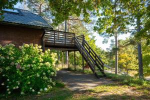 a wooden bridge over a path next to a building at Loft with lake views in Turku! in Turku