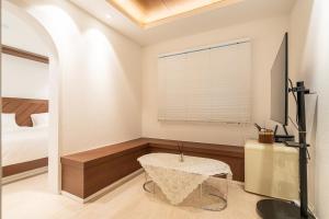 a bedroom with a table and a bed and a window at 하루재 in Seoul