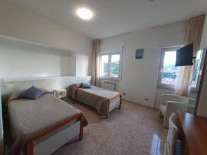 Ένα ή περισσότερα κρεβάτια σε δωμάτιο στο Hotel Ristorante Supersonik