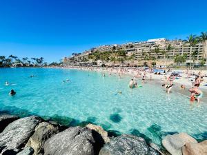 a group of people in the water at a beach at Seafront Studio in Patalavaca