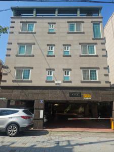 a building with a car parked in front of it at k조이스테이 in Pongsan-dong