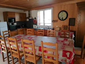 a kitchen with a table and chairs and a clock on the wall at Gîte À L'ancienne Boulangerie in Elsenheim +25 photos