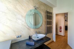 a bathroom with a sink and a mirror on the wall at Manno House in Genova +31 photos